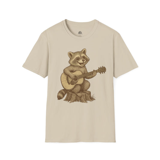Raccoon Folk T-Shirt in Sand. A raccoon strumming acoustic folk, gentler paws, same questionable nightlife.